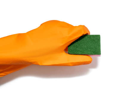 Orange rubber glove and rough textured washcloth isolated on white background. Cleaning the room with the help of tools in the form of a rubber glove and a washcloth for washingの写真素材
