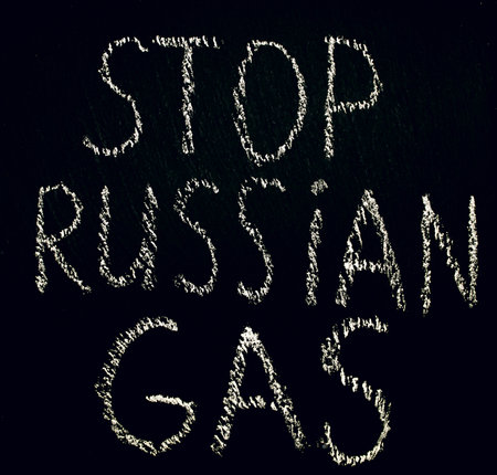 White chalk inscription of words on black board stop Russian gas. Embargo on the sale of energy products from Russia. Call not to buy Russian gas. Crisis and lack of energy resourcesの写真素材