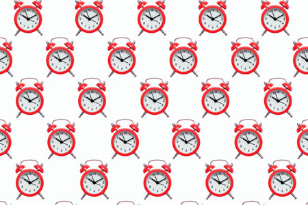 Pattern from red alarm clocks on a white isolated background. The background of many small alarm clocks in the form of a pattern. The concept of punctuality in the form of bright red alarm clocksの写真素材