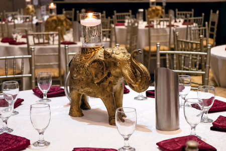 Indian restaurant with elephant decoration and candles. Preparing to meet guests at a wedding party in a restaurant. Indian style restaurant. Beautifully decorated table in an Indian restaurantの写真素材