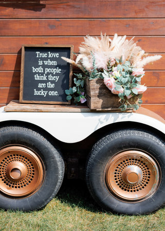 Wedding decorations at the wedding ceremony outdoors on the lawn. Wishes and words of wisdom for the bride and groom on a chalkboard as a wedding decoration. Board with words about love for newlywedsの写真素材