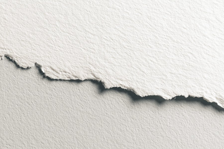 Textured white paper features a torn edge that exposes a smooth gray background, highlighting the contrast between the two surfacesの素材