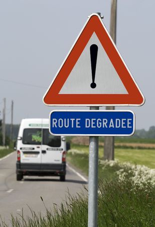 Damaged road warning signの写真素材