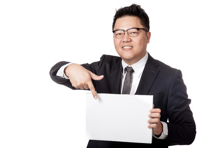Asian business man point to a blank sign in his hand isolated on white backgroundの写真素材