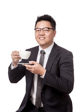 Asian business man drinking coffee and smile isolated on white backgroundの写真素材