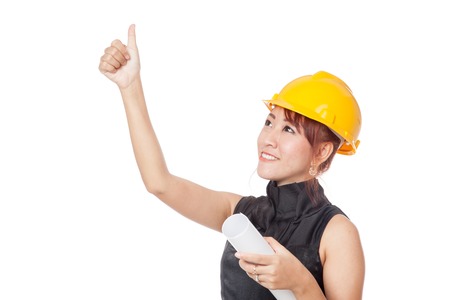 Asian architect girl looking up and  show thumbs up and smile isolated on white backgroundの写真素材