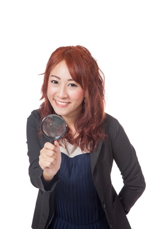 Asian office girl hold magnifying glass in front of her and smile isolated on white の写真素材
