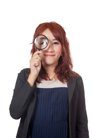 Asian office girl look through magnifying glass and smile isolated on white の写真素材