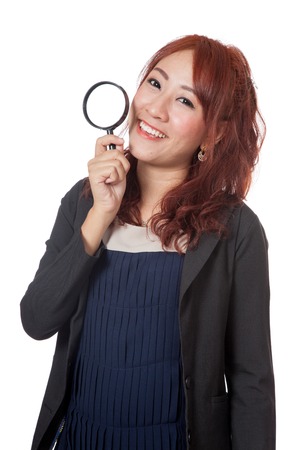 Asian office girl hold magnifying glass and smile isolated on white の写真素材