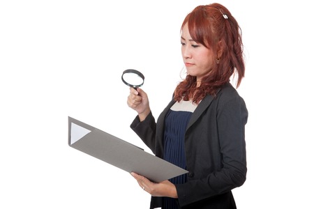 Asian office girl use magnifying glass check on data isolated on white backgroundの写真素材