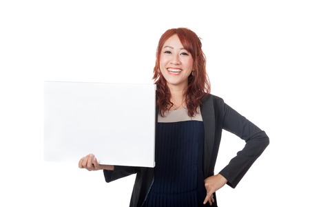 Asian office girl stand with arms akimbo and a blank sign isolated on white backgroundの写真素材