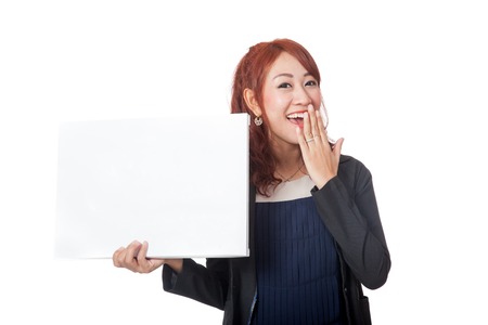 Asian office girl laughing with a blank sign isolated on white backgroundの写真素材