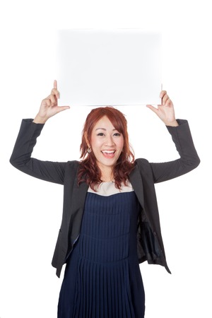 Asian office girl hold a blank sign with both hand over her head isolated on white backgroundの写真素材