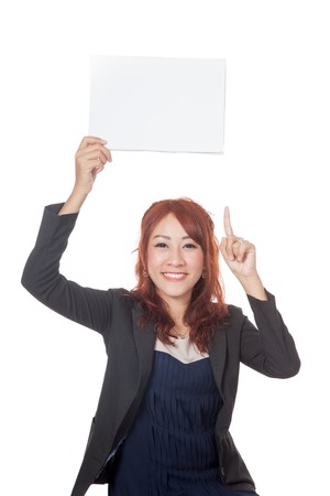 Asian office girl happy show a blank sign over her head and point up isolated on white backgroundの写真素材