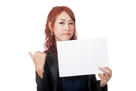 Asian office girl is in bad mood show a blank sign isolated on white backgroundの写真素材