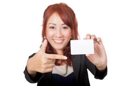 Asian office girl happy point to a blank card focus on card isolated on white backgroundの写真素材