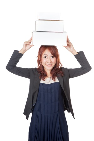 Asian office girl happy with 3 boxes over her head isolated on white backgroundの写真素材