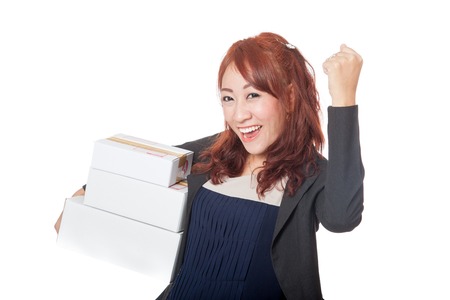 Asian office girl very happy with 3 boxes and fist pump isolated on white backgroundの写真素材