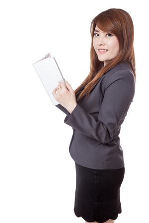Side view of Asian businesswoman reading a book look at the camera isolated on white backgroundの写真素材