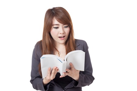 Asian businesswoman is excited  reading  a book isolated on white backgroundの写真素材