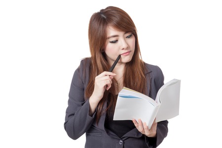 Asian businesswoman is  thinking read a book isolated on white backgroundの写真素材