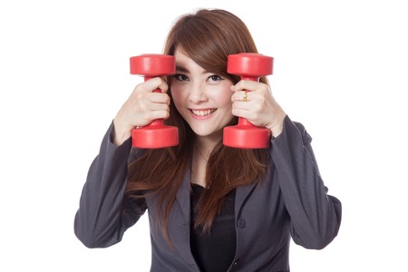 Asian businesswoman smile put her face between drumbbells isolated on white backgroundの写真素材