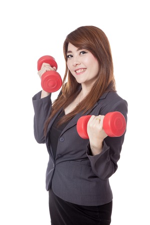 Asian businesswoman lift dumbbells and smile isolated on white の写真素材