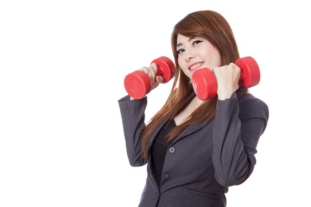 Asian businesswoman hold dumbbells with her both hand isolated on white の写真素材