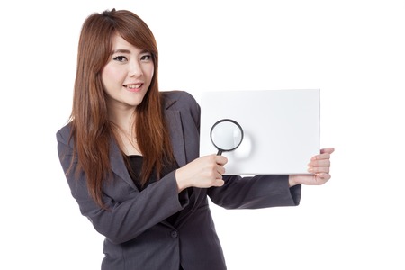 Asian businesswoman hold blank sign and  magnifying glass isolated on white backgroundの写真素材