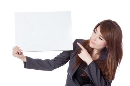 Asian businesswoman  point and look at a blank sign isolated on white backgroundの写真素材