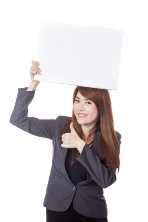 Asian businesswoman  thumbs-up hold a blank sign over head isolated on white backgroundの写真素材