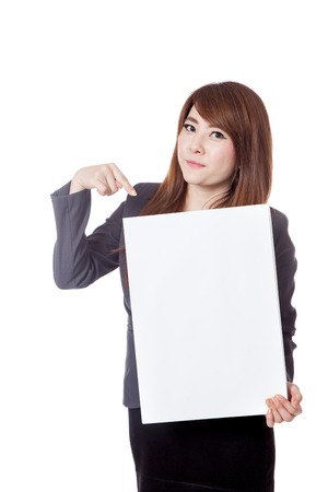 Asian businesswoman point to a vertical blank sign isolated on whtie backgroundの写真素材