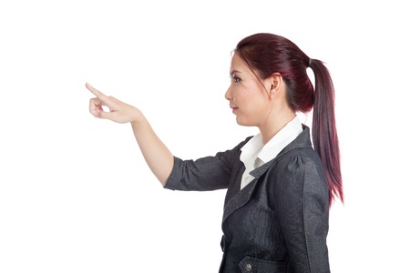 Side view of Asian business woman touching the screen with her finger isolated の写真素材