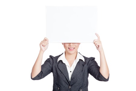 Asian businesswoman hold a blank sign close her  face and smile isolatedの写真素材