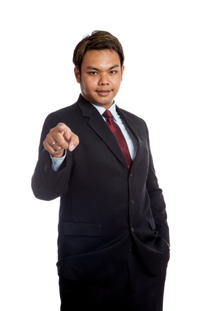 Asian businessman in suit point to camera isolated の写真素材