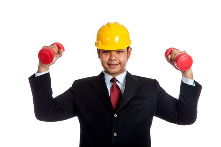 Asian engineer man hold red dumbbell with both hand  isolatedの写真素材