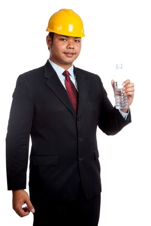Asian engineer man hold a bottle of drinking water isolated の写真素材