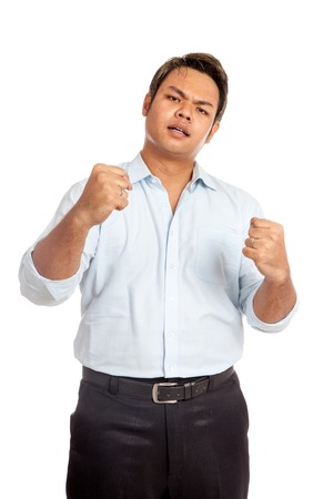 Asian man hold his fists with anger  isolated の写真素材