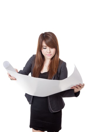 Asian architect girl reading a plan  isolated on white backgroundの写真素材