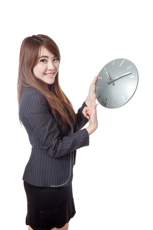 Asian Businesswoman point to a clock and smile  isolated on white backgroundの写真素材