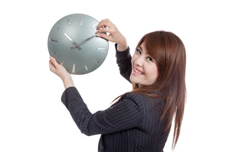 Asian Businesswoman move a clock hand and turn back  isolated on white backgroundの写真素材