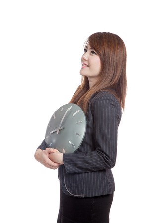 Asian Businesswoman hold a clock and smile  isolated on white backgroundの写真素材