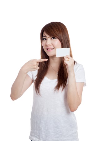 Asian girl point to a white card and smile isolated on white backgroundの写真素材