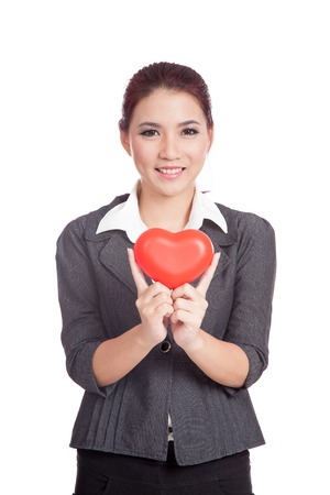 Asian businesswoman show red heart and smile isolated on white backgroundの写真素材