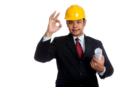 Asian engineer man hold blueprint and OK sign isolated on white backgroundの写真素材