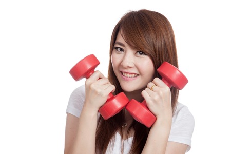 Asian girl hold dumbbells close to her face and smile isolated on white backgroundの写真素材
