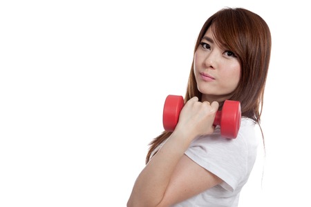 Happy Asian girl lift dumbbell look at camera isolated on white backgroundの写真素材