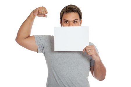 Asian strong man  flexing biceps  close his mouth with a blank sign isolated on white backgroundの写真素材