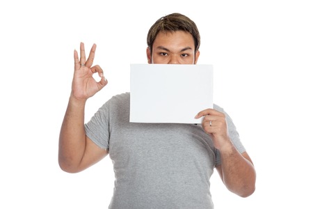 Asian strong man show OK sign and a blank sign isolated on white backgroundの写真素材