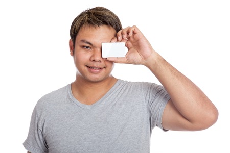 Asian man close his eye with a blank card isolated on white backgroundの写真素材